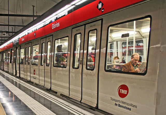 guy reading newspaper in a metro